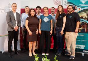 Group photo of the B-PREPARED project team standing together at the Hungarian National Museum, featuring men and women in casual and formal attire, with project banners and institutional logos in the background.